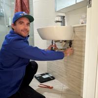 Plumber fixing bathroom hand basin