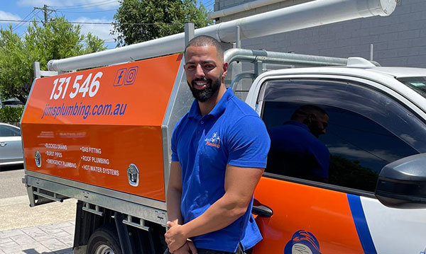 Plumber standing next to Jim's ute
