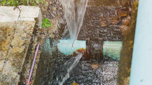 Burst underground pipe rapidly leaking water