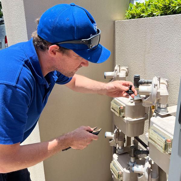 Plumber working on mains gas boxes at front property