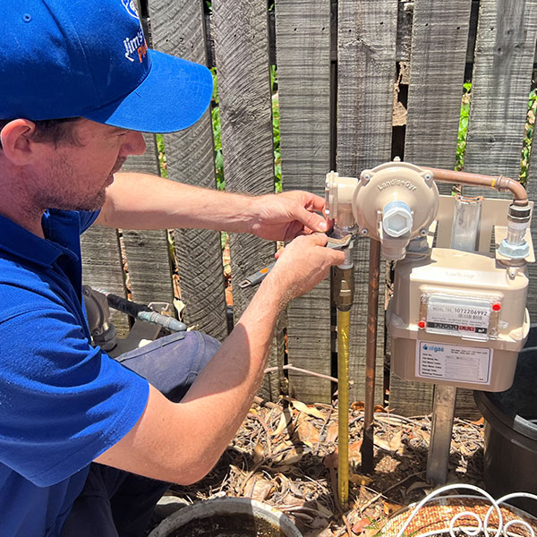 Gasfitter working on mains gas at property
