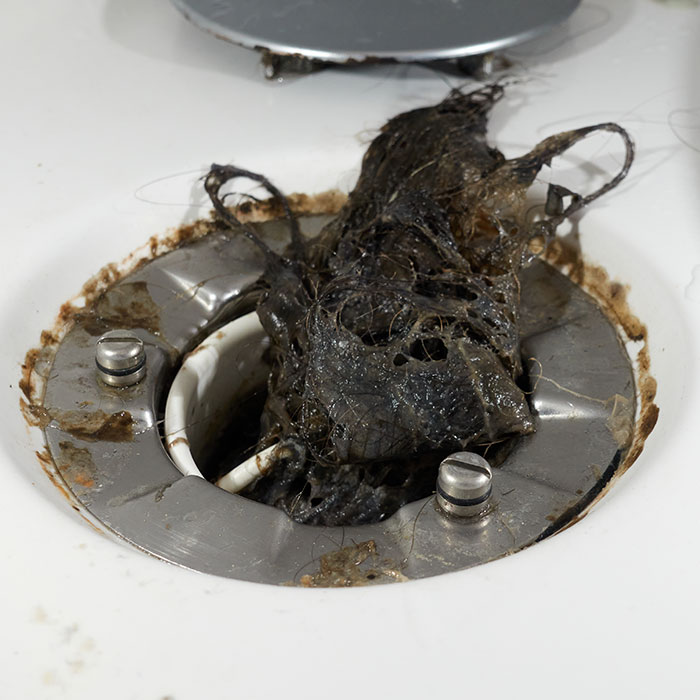Hair coming out of blocked drain