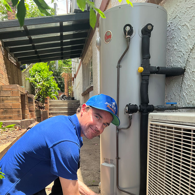 Plumber smiling working on hot water system