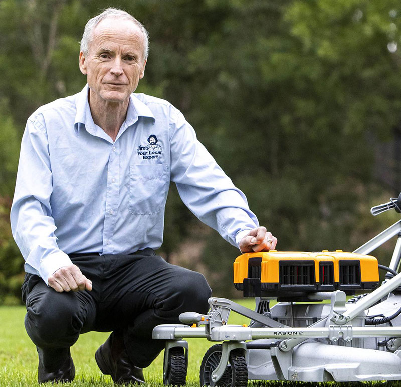 Jim Penman next to lawn mower