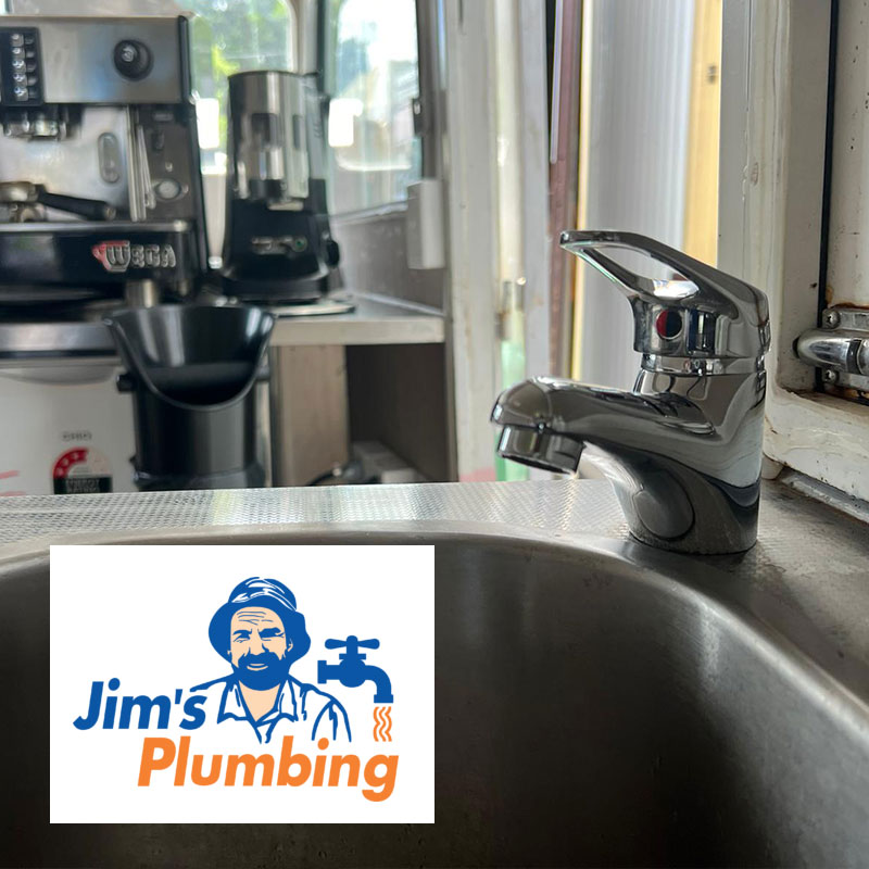 Closeup of a leaking tap with Jim's Plumbing logo superimposed