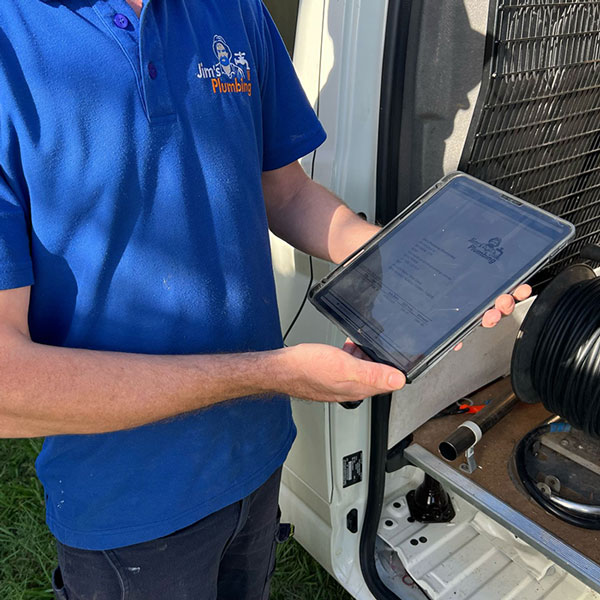 Closeup of plumber showing customer a quote